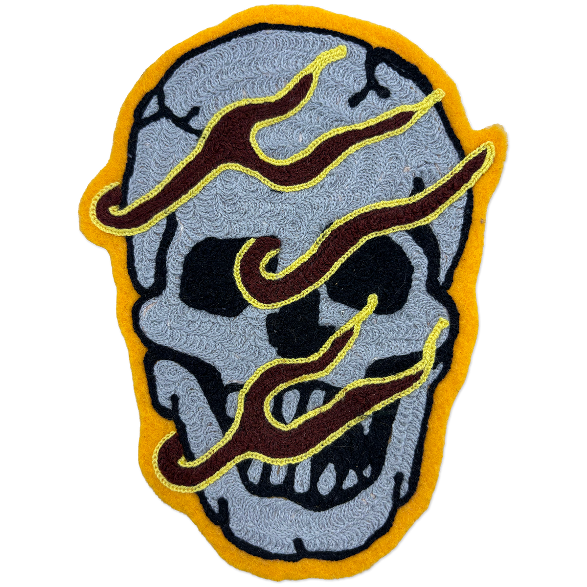 Hand-made chainstitch patch depicting a flaming skull.