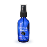 Blue spray bottle labeled 'Tropical Citrus' on a white background